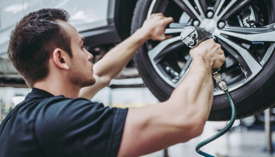 Mechanic Installing Tires on a Vehicle