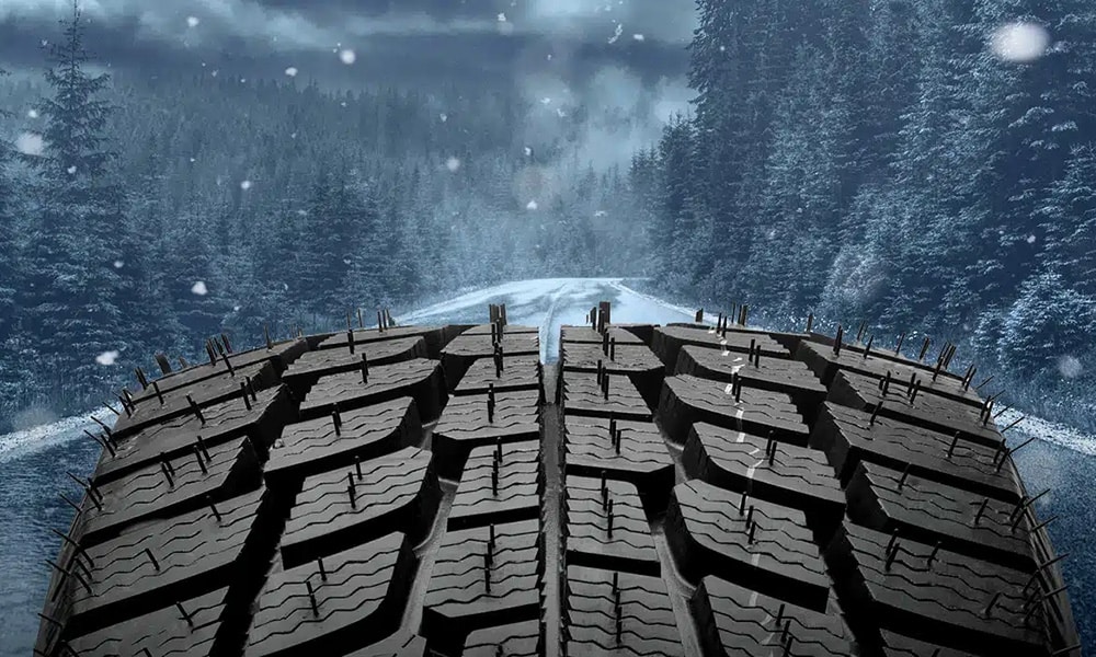 A tire traversing on a road during a rain storm